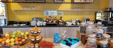 A breakfast buffet with various food items and beverages.