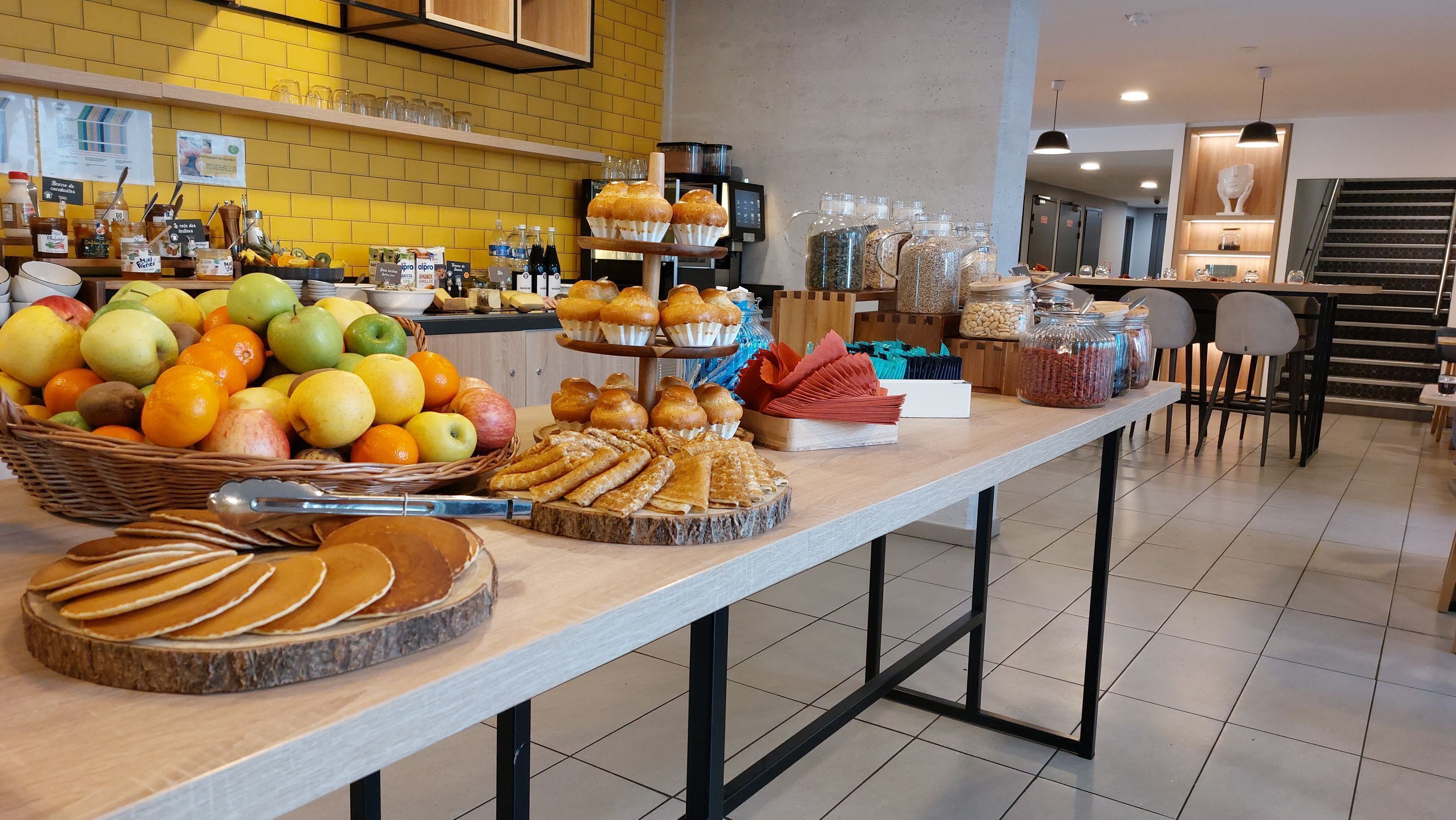 A buffet setup with various food items and beverages.