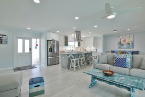 Relax in this stylish living space with a large sofa, matching ottoman, and glass coffee table.