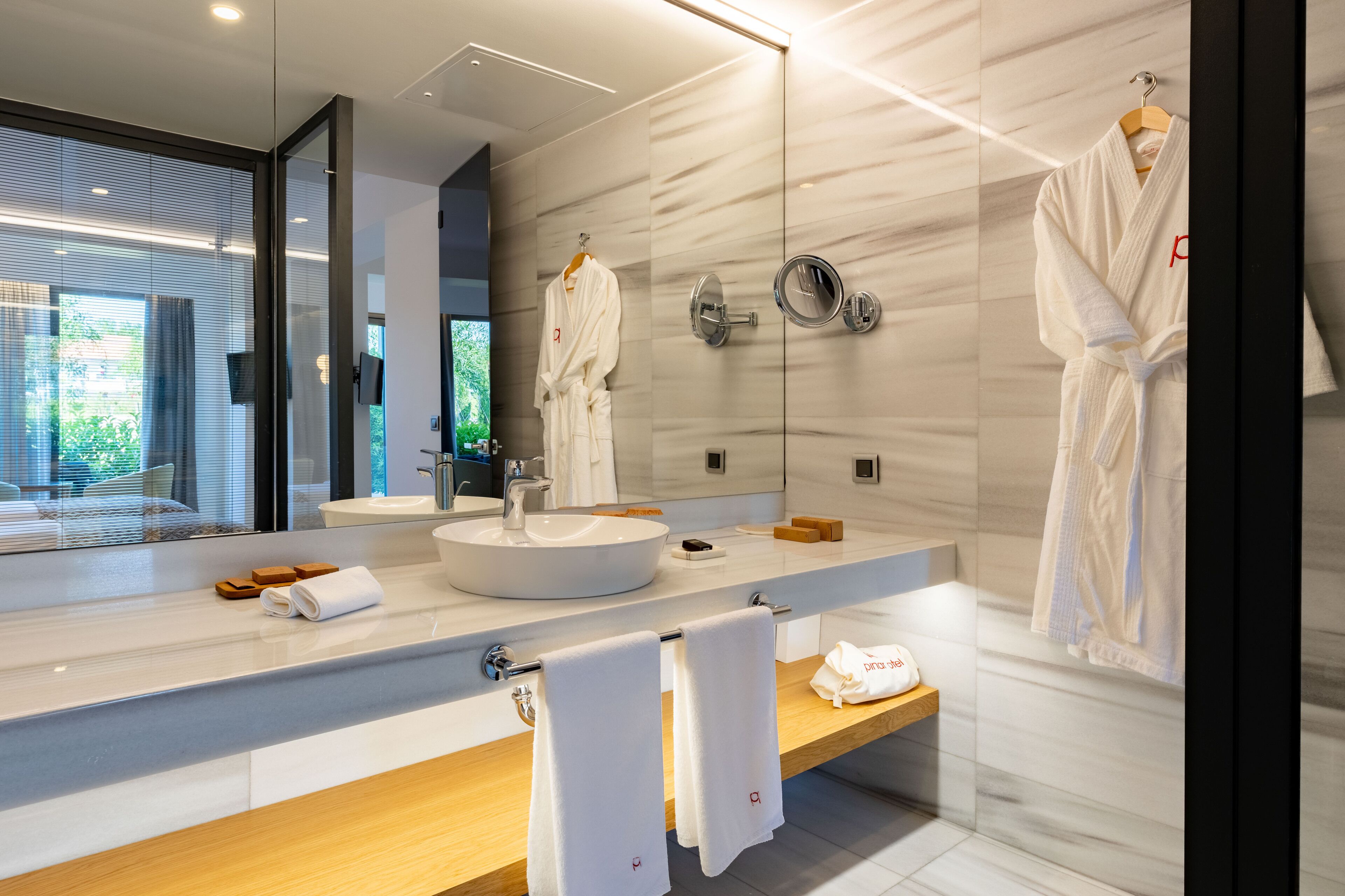 junior suite | bathroom | shower, rainfall showerhead, hair dryer, bathrobes