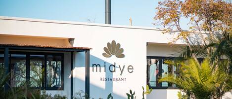 A modern building with a sign that reads "midye restaurant."