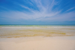 A beach with clear skies and calm waters.