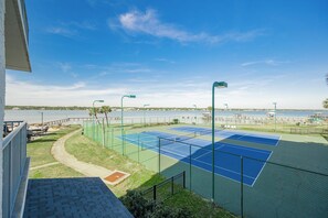 A tennis court with a view of a lake and a dock. - Gulf Shores Surf & Racquet 202B | Lagoon Views (Gulf Shores)