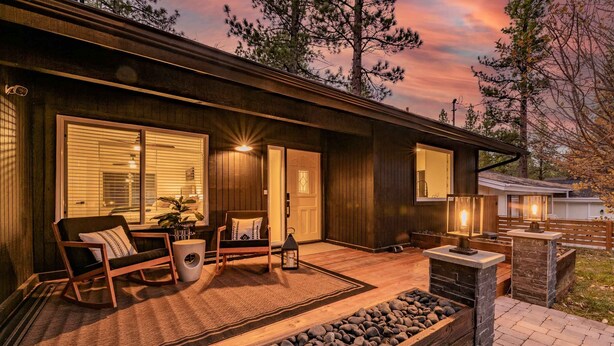 A modern house with a porch, seating area, and a stone pathway. - Modern Mountain Cabin w/ Hot Tub, Game Room & Fire Pit (Big Bear)