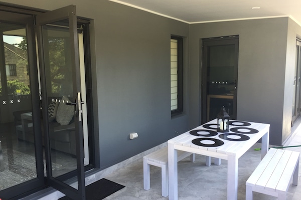 Large balcony with seating and BBQ area opening from kitchen and lounge area.