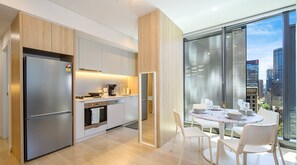 Enjoy meals in the kitchen with stainless steel appliances and an oven, paired with a dining area offering a city view.
