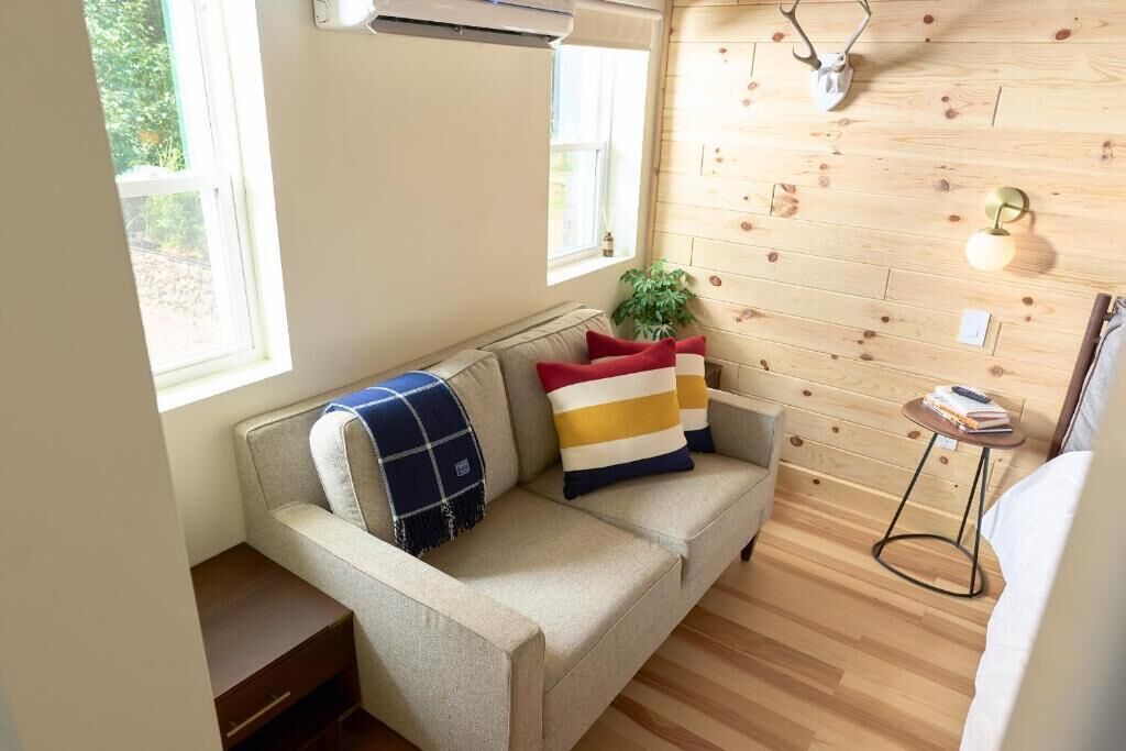A cozy room with a sofa, a small table, and a plant.