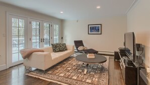 A living room with a sofa, a recliner, a coffee table, and a TV. - New Luxury Listing: 5,000 sq/ft Secluded House (Weston)