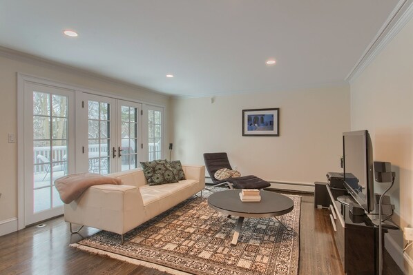 A living room with a sofa, a recliner, a coffee table, and a TV.