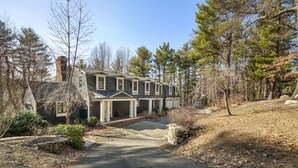 A two-story house with a stone foundation, a covered porch, and a driveway leading to the front door. - New Luxury Listing: 5,000 sq/ft Secluded House (Weston)