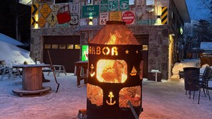 A KFC restaurant with a garage and a signboard displaying various directions and warnings. - 3 Bedroom Loft With Game Room ~ In The Heart Of Downtown Copper Harbor (Copper Harbor)