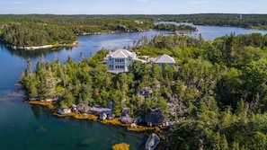 A large house surrounded by dense forest and a lake. - Spacious villa by the sea (East Dover)