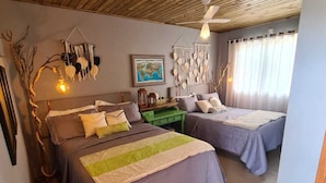 A cozy bedroom with two beds, a wooden ceiling, a world map on the wall, and a hanging macrame decoration. - Refúgio dos Coiotes (Cambara do Sul)