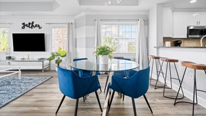 A modern kitchen with white cabinets, a stainless steel microwave, and a coffee machine. - Condo with Golf Course Views | Near Attractions (Kissimmee)