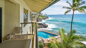 A balcony with a view of the ocean and a swimming pool. - Poipu Shores 402A - Full A/C Luxury, Sublime Views (Koloa)