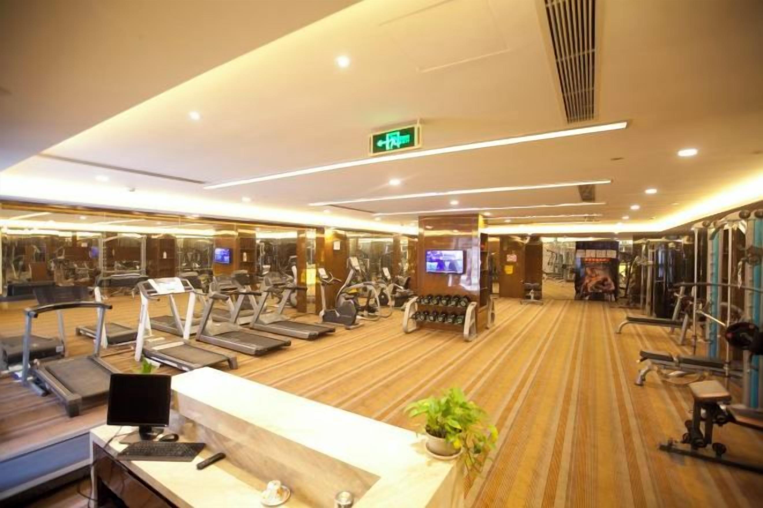 A gym with treadmills, stationary bikes, and weight machines.