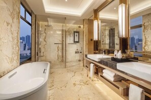 A modern bathroom with a large bathtub, two sinks, a glass shower enclosure, and a city view. - Leida Hotel (Dongtai)