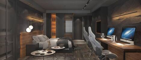 A modern office space with a sofa, desk, and multiple monitors.