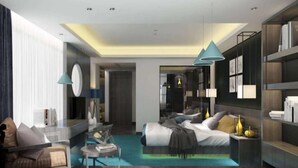 Une chambre d’hôtel moderne équipée d’un lit, d’un coin salon et d’un bureau.