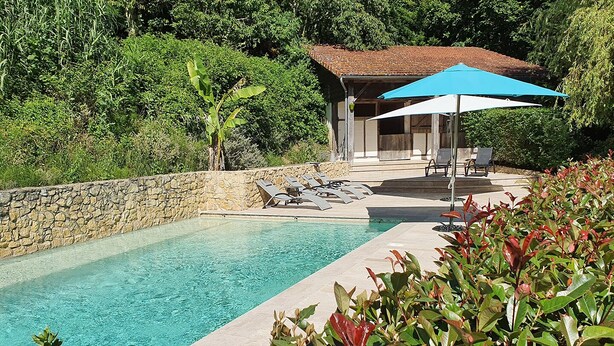A swimming pool with lounge chairs and a covered seating area. - Quiet house with large garden and pool, in the Entre-deux-Mers (Saint-Vincent-de-Pertignas)