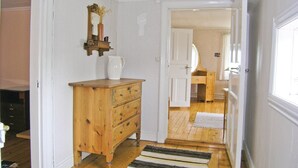 A hallway with a wooden dresser, a mirror, and a door leading to a bathroom. - Gorgeous home in Bodafors with kitchen (Bodafors)