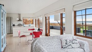 A spacious room with a large window offering a view of the outdoors. - 2 bedroom awesome home in Holbæk (Holbæk)