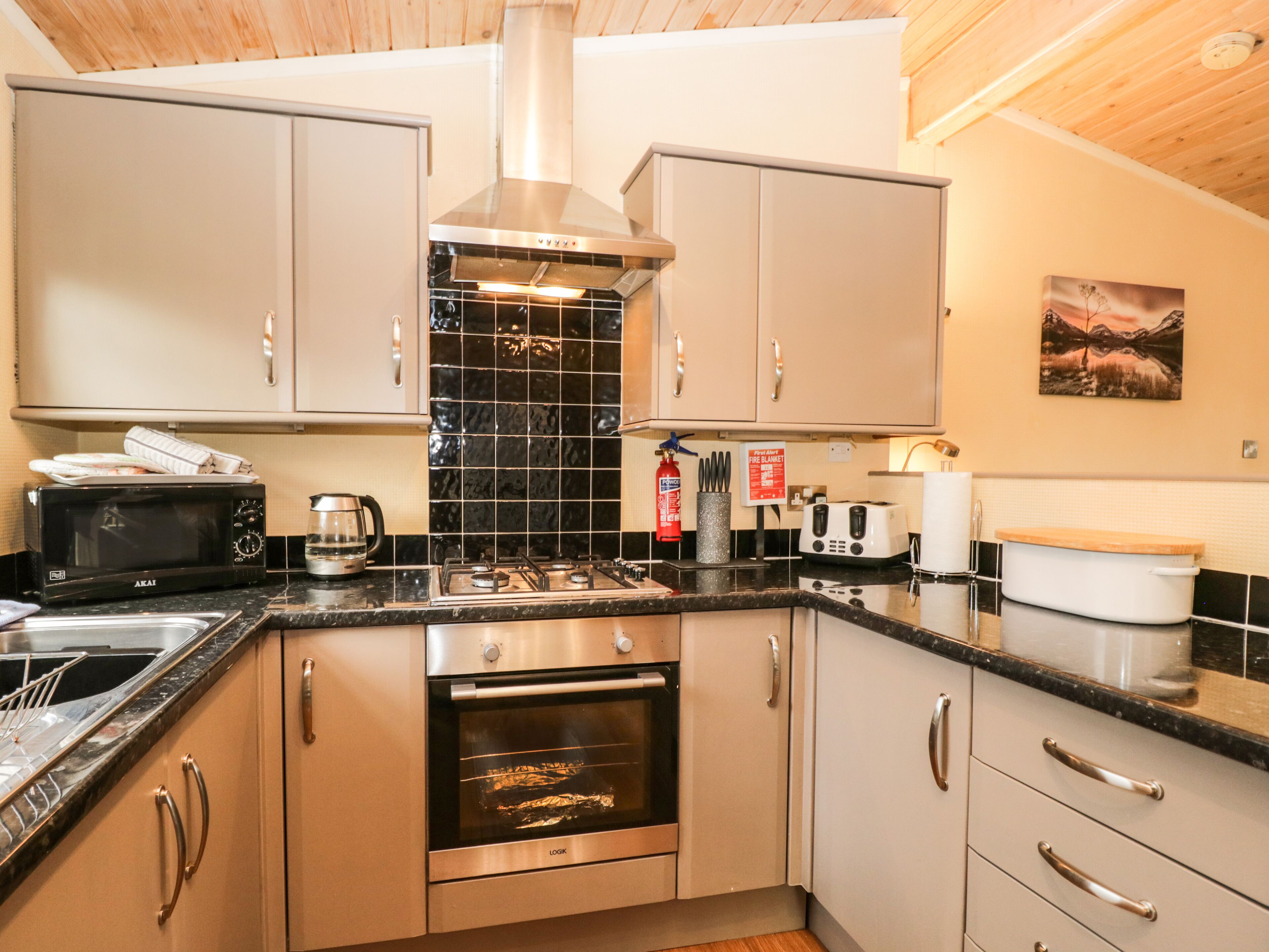 A modern kitchen with stainless steel appliances, a gas stove, and a built-in oven.