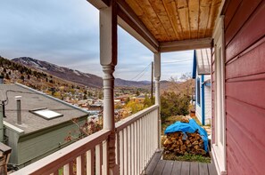 Enjoy the serene view of the surrounding mountains from this cozy porch.