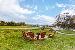 Enjoy outdoor dining or socializing in this seating area with a clear view of the surrounding neighborhood.