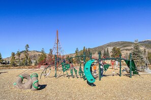 Kids can play on the slide and climbing elements in this outdoor playground.
