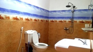 A bathroom with a beach mural, a toilet, a shower, and a sink.