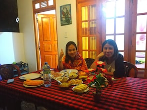 A dining table with various dishes and a water bottle.
