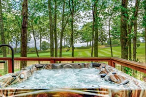 A hot tub with a view of a golf course.
