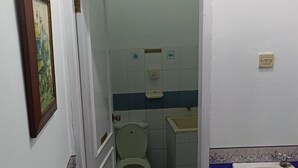 A bathroom with a toilet, sink, and a blue and white tiled floor. - Tempat Nginap 2BR Ciater Highland Resort (Ciater)