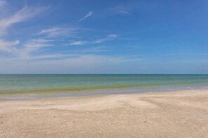 A beach with clear skies and calm waters.