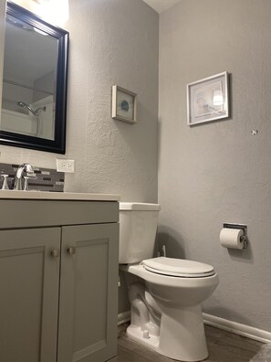 Combined shower/bathtub, towels, soap, toilet paper