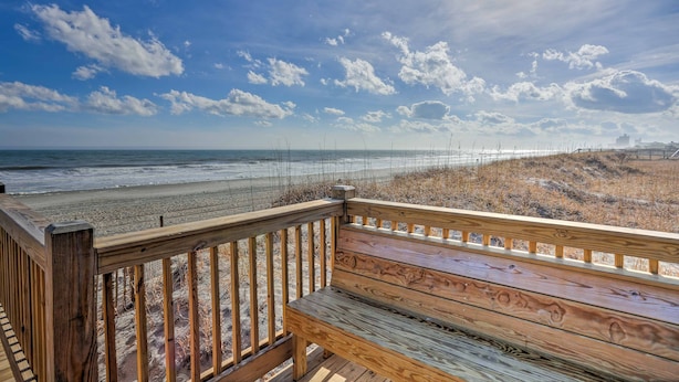 A wooden deck with a bench overlooking a beach. - Magnolia Pointe Condo with Community Pool & More! (Myrtle Beach)