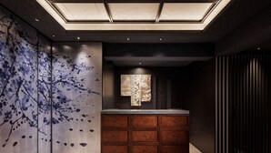 A modern bathroom with a large mirror, wooden cabinets, and a unique wall art design. - KYOTO GRANBELL HOTEL hanareya (Kyoto)