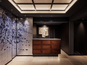 A modern bathroom with a large mirror, wooden cabinets, and a unique wall art design. - KYOTO GRANBELL HOTEL hanareya (Kyoto)