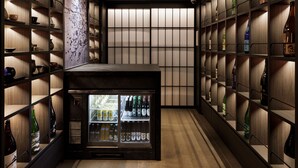 A bar area with shelves of bottles and a refrigerated display. - KYOTO GRANBELL HOTEL hanareya (Kyoto)