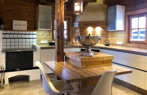 A wooden interior with a kitchen area, a dining table with chairs, and a sign reading 'MR PORTER'.
