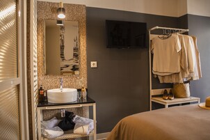Ein modernes Badezimmer mit großem Spiegel, Waschbecken und Handtuchhalter.