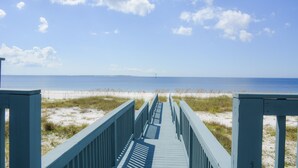 A wooden boardwalk leading to a beach with a clear sky and distant horizon. - Herring House- Gulf front, St Joe Beach, WIFI, No pets, Sleeps 7 (Saint Joe Beach)