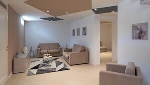 A modern living room with a sofa set, a coffee table, and artwork on the walls. - Villa Levante (Lido di Camaiore)