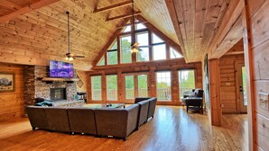 A spacious living area with a stone fireplace, a large wooden ceiling, and a pool table. - Escape to Daltons Creek Cabin in Creston, NC, perfect for family fun! (Creston)