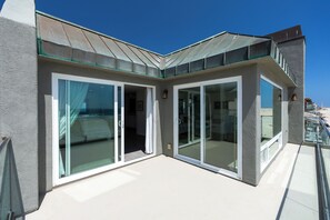A modern building with large glass doors and a balcony. - 1617O: 4  BR, 3  BA House in Oxnard, Sleeps 8 (Oxnard)