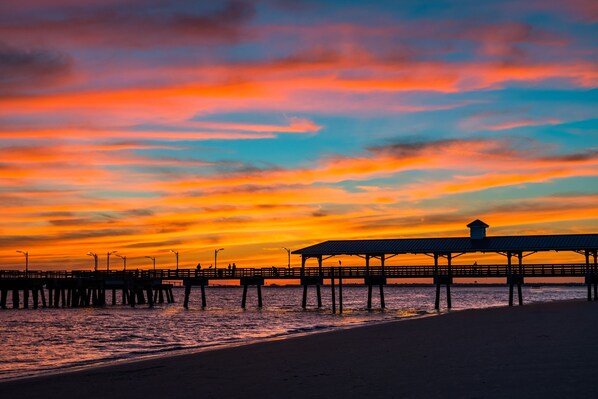 Stroll along the pier, taking in the serene views of the tranquil water below.