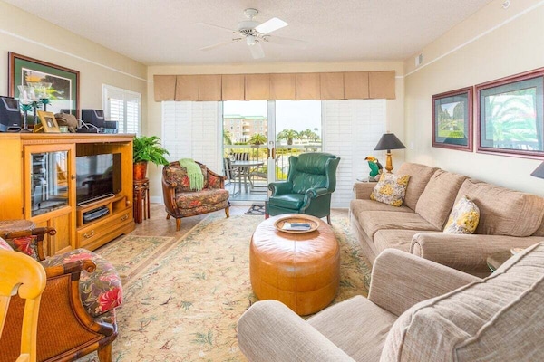 Saint Simons Grand #107 Living space with sofa set, chairs, fan, and balcony access
