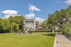 Enjoy a peaceful retreat in our beautifully maintained outdoor space, featuring a lawn, boardwalk, picnic area with tables and grills.