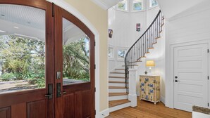 A wooden door, a staircase, and a white door. - Large Luxury Home with Pool! (Saint Simons Island)